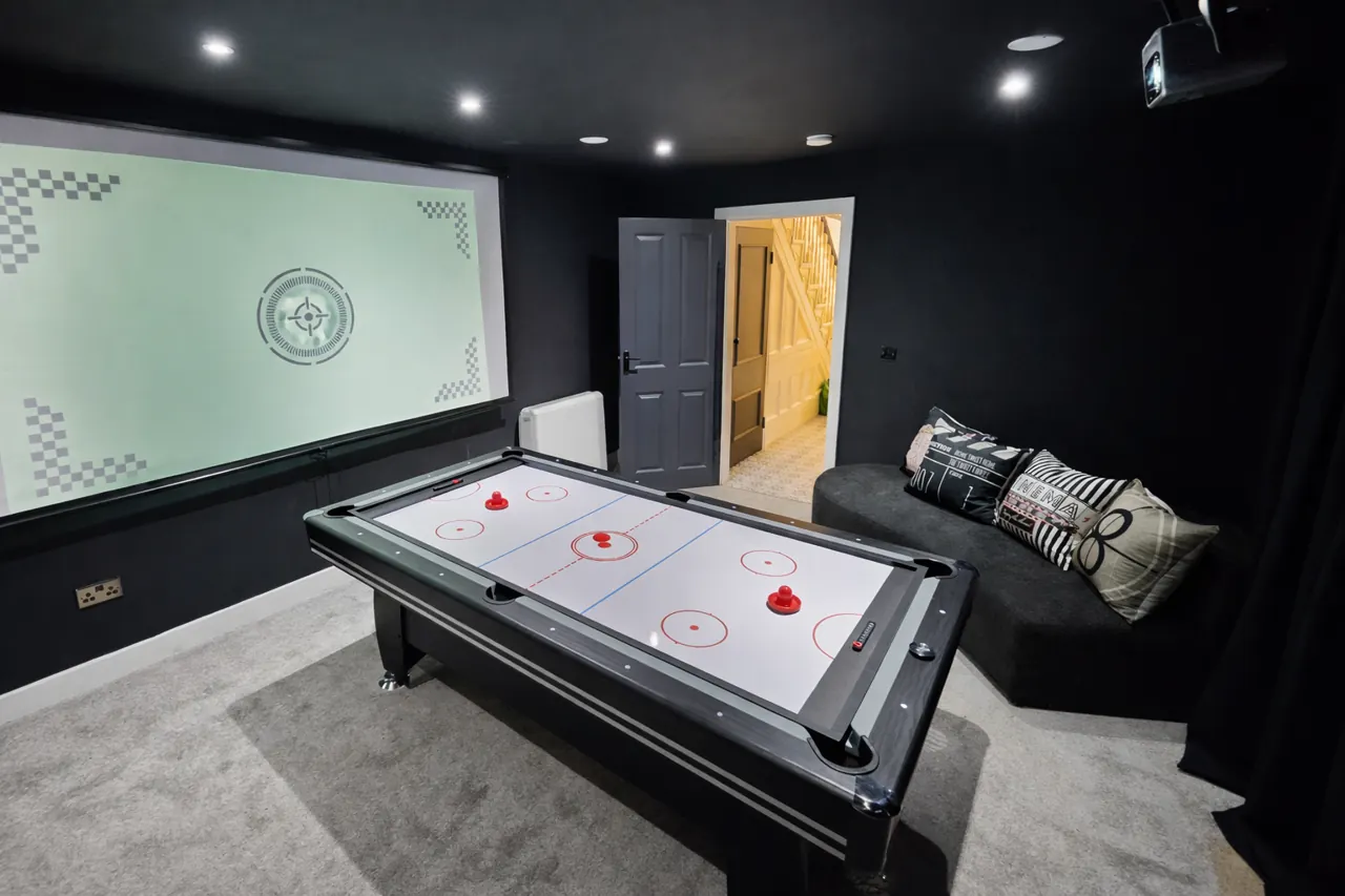 Games room with air hockey table and sofa
